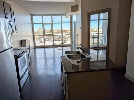 Top Floor 1-bedroom condo, floor to ceiling windows overlooking Downtown | 6307 - 11811 Lake Fraser Drive SE, Calgary