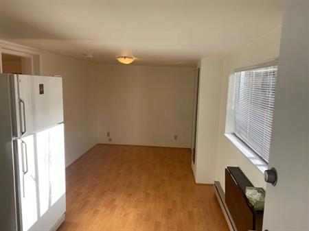 Kits 1Br unfurnished apartment on the ground level with wood flooring