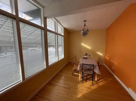 Room with furnitures beside UOC | 2848 Brecken Road Northwest, Calgary