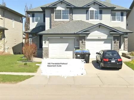 Beautiful three bedroom unit next to bus stop and backing on trail and green | 166 Panatella Boulevard Northwest, Calgary