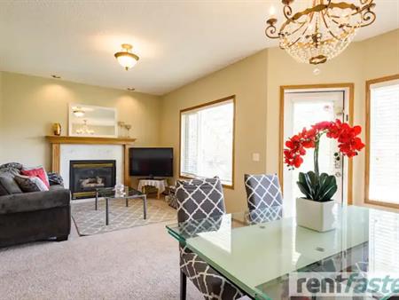 Lake access! Spacious, furnished and bright 2-bedroom walkout in Arbour Lake | Calgary